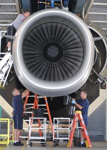Aviation maintenance technicians work on a C-17 engine at the engine test cell building here June 18. The all-civilian engine shop installs, inspects and repairs five to six engines a month. (U.S. Air Force photo/Senior Airman Katie Gieratz)(Released)
