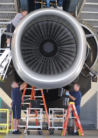 Aviation maintenance technicians work on a C-17 engine at the engine test cell building here June 18. The all-civilian engine shop installs, inspects and repairs five to six engines a month. (U.S. Air Force photo/Senior Airman Katie Gieratz)(Released)
