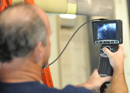Tim Gorman uses a bore scope to look into a hot part of the engine at the C-17 engine test cell building here June 18. The all-civilian engine shop is responsible for installing, inspecting and repairing engines for the Air Force. Mr. Gorman is an aviation maintenance technician with United Airlines. (U.S. Air Force photo/Senior Airman Katie Gieratz)(Released)

