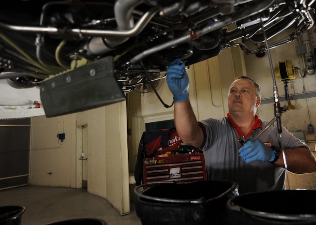 Danny Page drains the fuel filter on a C-17 engine in the test cell here June 18. The fuel filter must be drained before it can be inspected for contaminates. The all-civilian engine shop installs, inspects and repairs five to six engines a month. Mr. Page is an aviation maintenance technician with United Airlines. (U.S. Air Force photo/Senior Airman Katie Gieratz)(Released)
