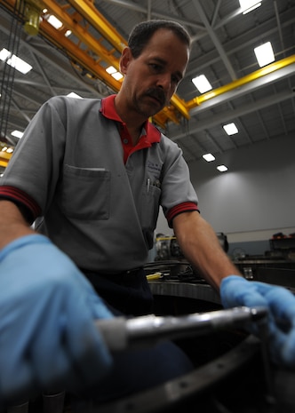Jerry Zuk installs a forward ring on a thrust reverser here June 18. The forward ring attaches the thrust reverser to the engine. The all-civilian engine shop installs, inspects and repairs five to six engines a month. Mr. Zuk is an aviation maintenance technician with United Airlines. (U.S. Air Force photo/Senior Airman Katie Gieratz)(Released)
