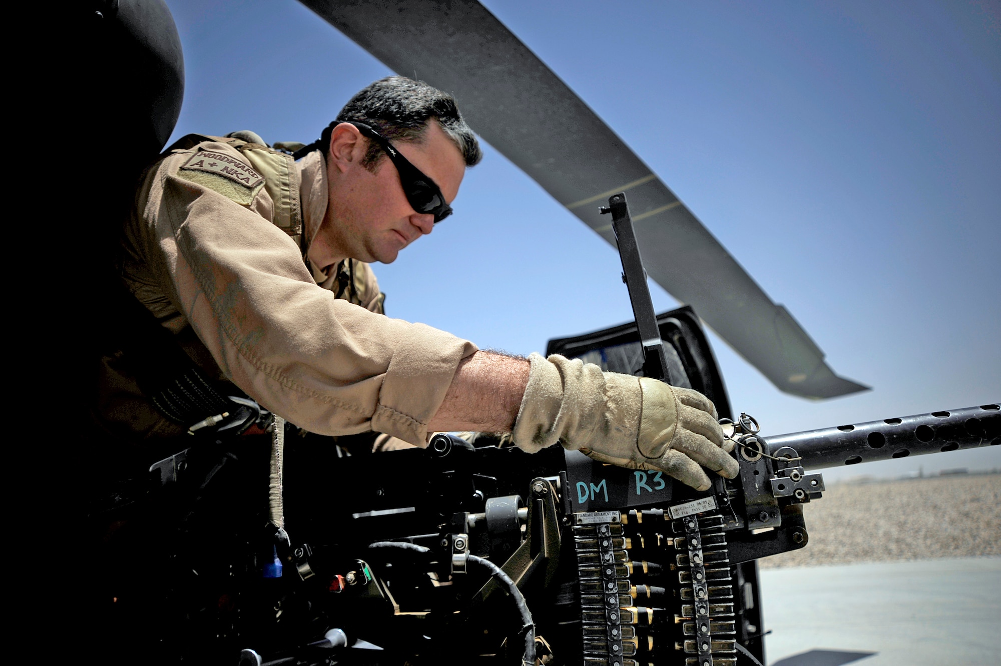 Tech. Sgt. Brock Woodward performs a preflight inspection of a .50 caliber machine gun June 23 at Camp Bastion, Afghanistan. Sergeant Woodward is a flight engineer with the 129th Expeditionary Rescue Squadron. (U.S. Air Force photo/Staff Sgt. Shawn Weismiller) 