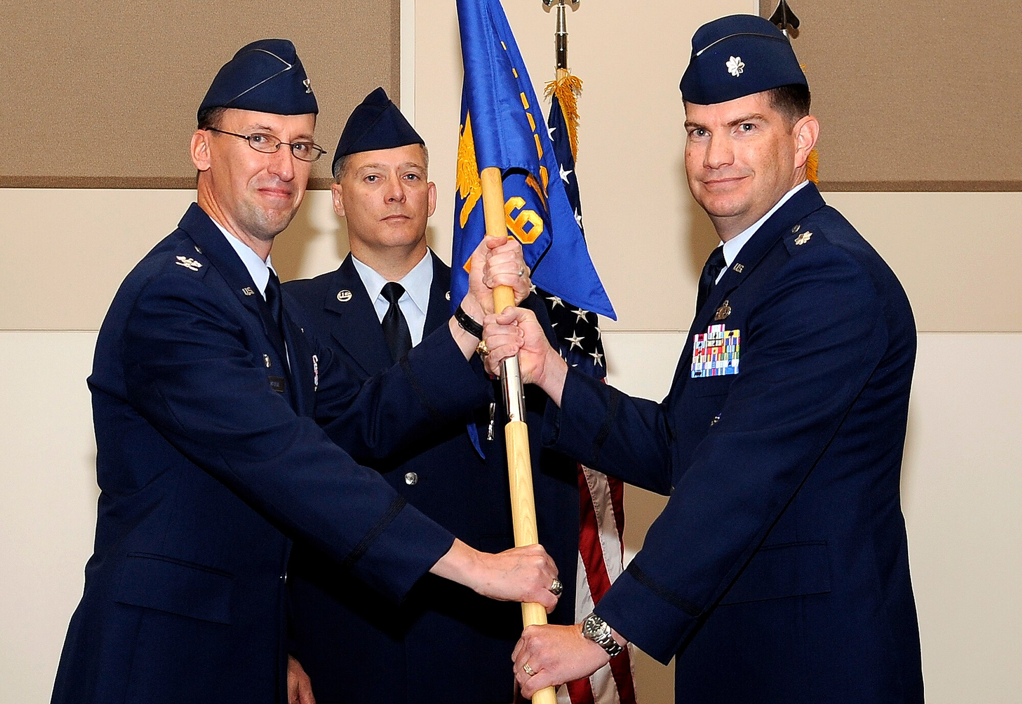 BUCKLEY AIR FORCE BASE Colo. – Col. Darren Medlin, 544th Intelligence Group commander, Peterson AFB, passes command of the 566th Intelligence Squadron over to new commander, Lt. Col. David Scanlon here, June 30. (U.S. Air Force photo by: Senior Airman Steven Czyz)