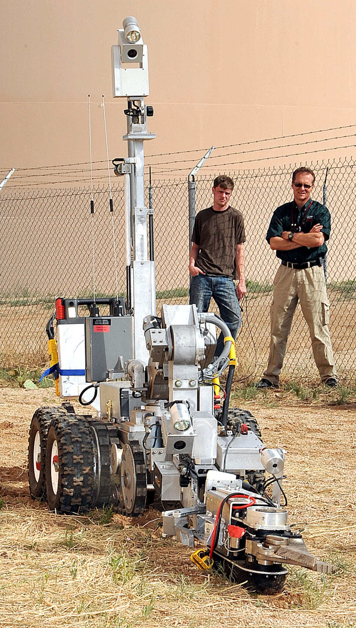 Observing the precision of the competing teams, judges watch closely as a team navigates their robot through one of the obstacles during an exercise for the Western National Robot Rodeo. The rodeo was hosted by Sandia National Laboratories June 22-25. U.S. Air Force photo by Todd Berenger