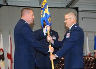Colonel John Lipinski 615th Contingency Response Wing commander, hands the 570th Contingency Response Group Guideon to Colonel  David Chandler during the 570th CRG  change of command ceremony on 25 June 2009. (U.S. Air Force photo by Civ/Nan Wylie) 