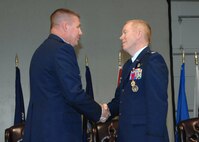 Colonel John Lipinski 615th Contingency Response Wing commander, left, congratulates Colonel Steven Jordon the outgoing   570th Contingency Response Group commander after presenting the Legion of Merit Medal to Colonel Jordan during the 570th Contingency Response Group change of command ceremony. (U.S. Air Force photo by Civ/Nan Wylie) 