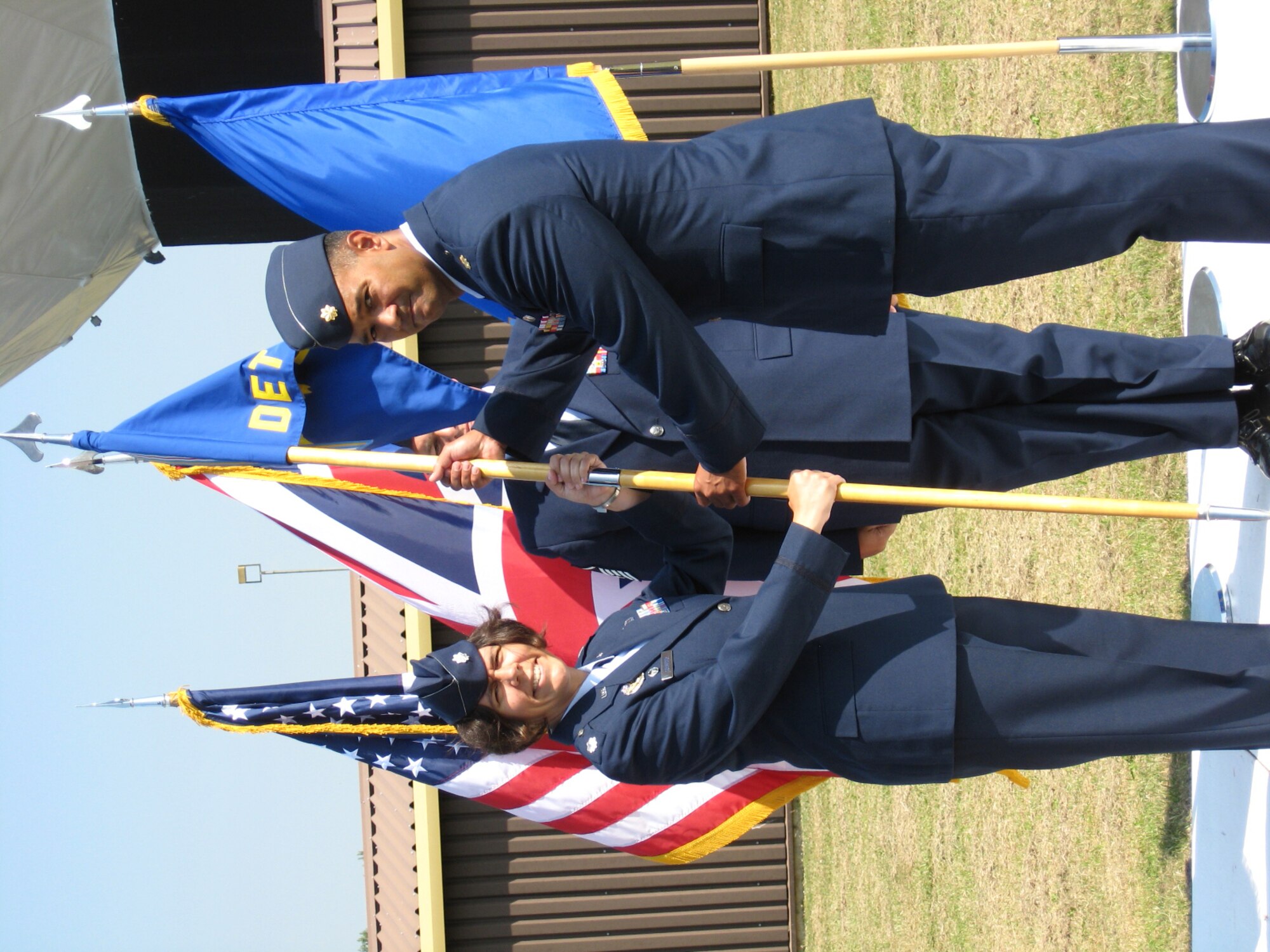 Lt. Col. Suzanne Streeter, 18th Intelligence Squadron Commander, passes the 18th Intelligence Squadron , Detachment 4 guidon to Maj. Brandon Beauchan as he assumes command at Royal Air Force Fetlwell, England July 2, 2009. (USAF photo by SSgt. Darryl Hambly) 