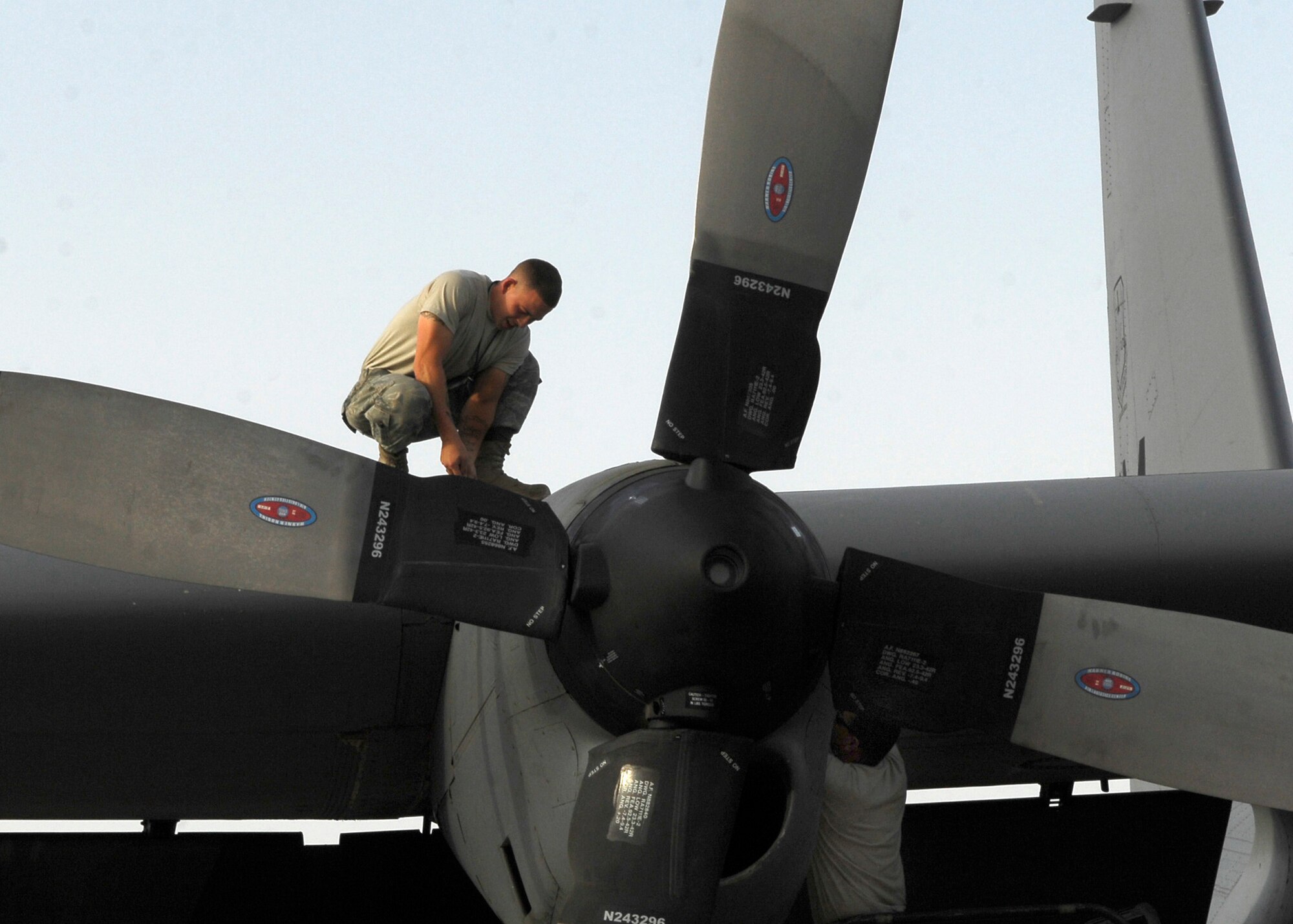 BAGRAM AIR FIELD, Afghanistan - Staff Sergeant Andres Jaramillo, working on the wing, and Tech Sgt. Jose Rodriguez, both from the 41st Expeditionary Aircraft Maintenance Unit, perform maintenance on the EC-130 Compass Call. (U.S. Air Force photo/Senior Airman Felicia Juenke)