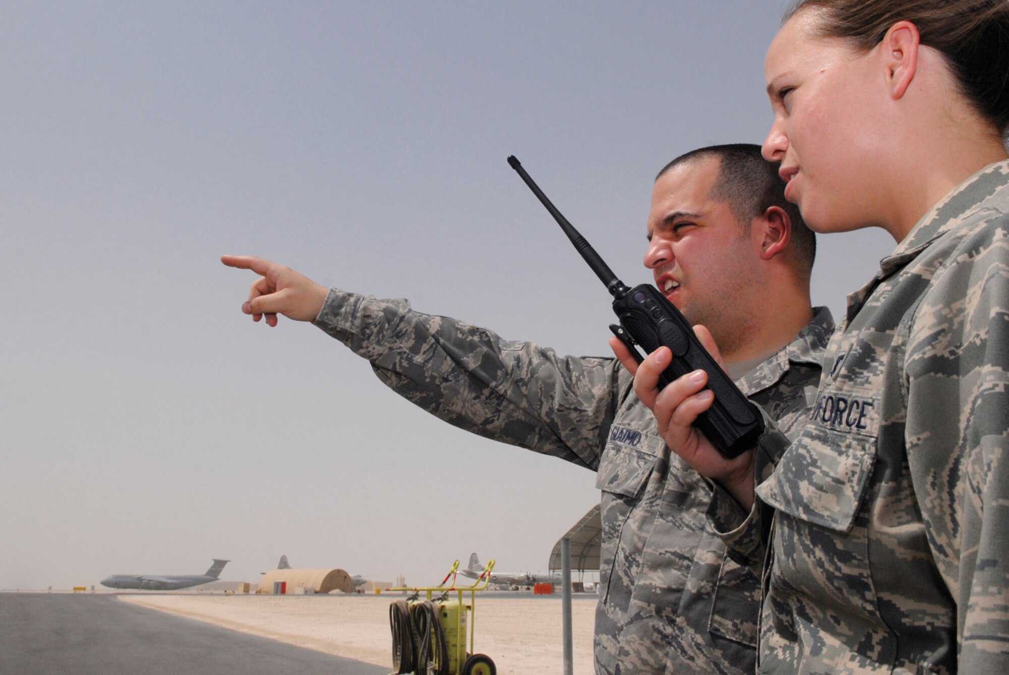 Staff Sgts. Nicholas Giaimo, 379th Expeditionary Operations Support Squadron deputy airfield manager, and Myshel Rush, 379 EOSS airfield management supervisor, survey the flightline for potential violations June 30, in Southwest Asia. Airfield management ensures the safety of aircrew and aircraft by coordinating and de-conflicting departures and arrivals.  Sergeant Giaimo hails from Lewisville, Texas, and is deployed from Elmendorf Air Force Base, Alaska. Sergeant Rush hails from Lawton, Okla., and is deployed from Davis Monthan Air Force Base, Ariz.  Both are deployed in support of Operations Iraqi, Enduring Freedom and Combined Joint Task Force - Horn of Africa.  (U.S. Air Force photo/Senior Airman Andrew Satran) 
