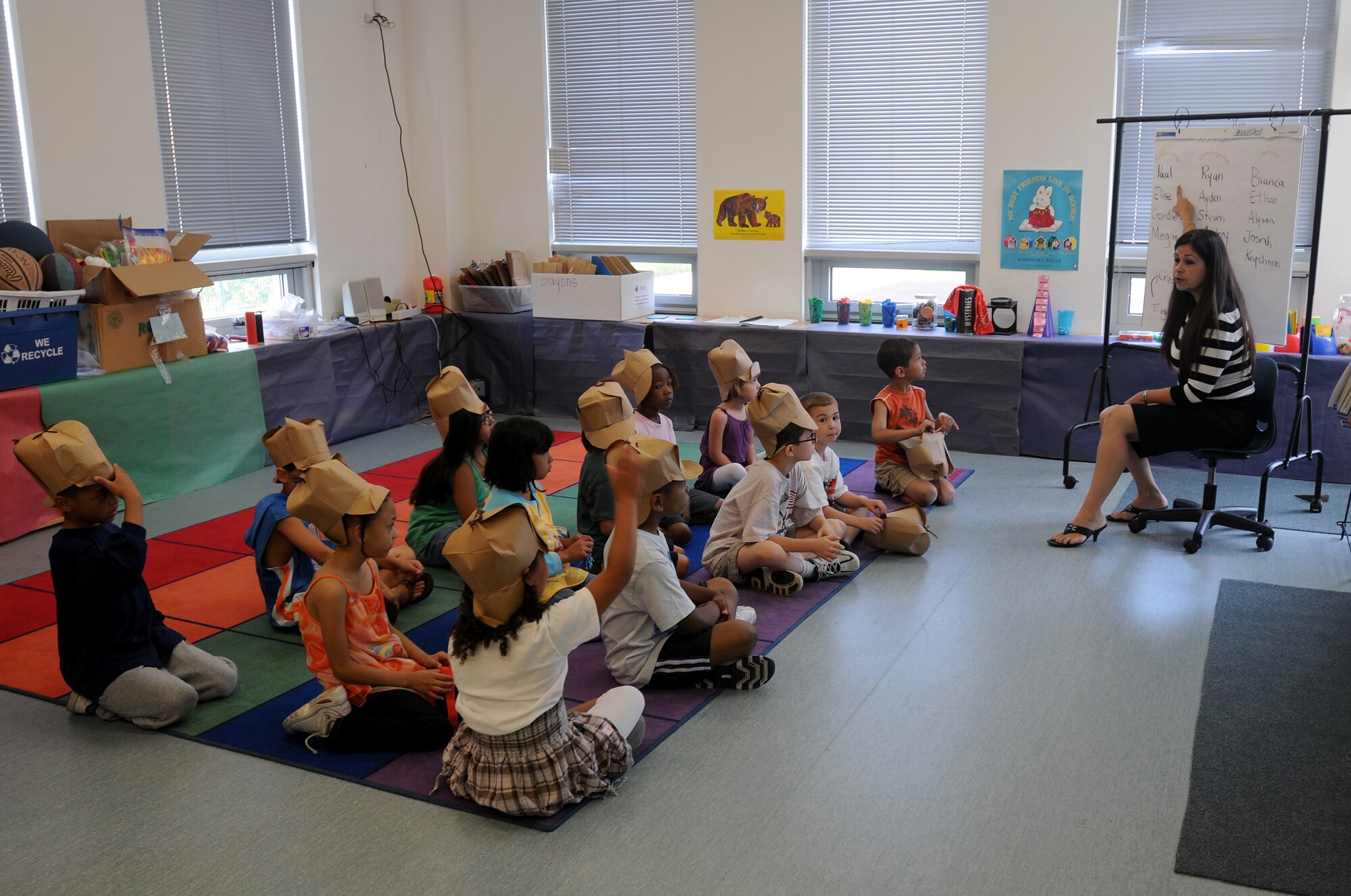 Ms. Carmen Colon, Aviano Air Base Elementary School teacher, talks to her students about the activities they will be involved in through the Voyager program.  This year's summer enrichment program theme is Mysteries Adventure which allows children to act as detectives and scientists while they uncover clues.  (U.S. Air Force photo/Airman 1st Class Ashley Wood)