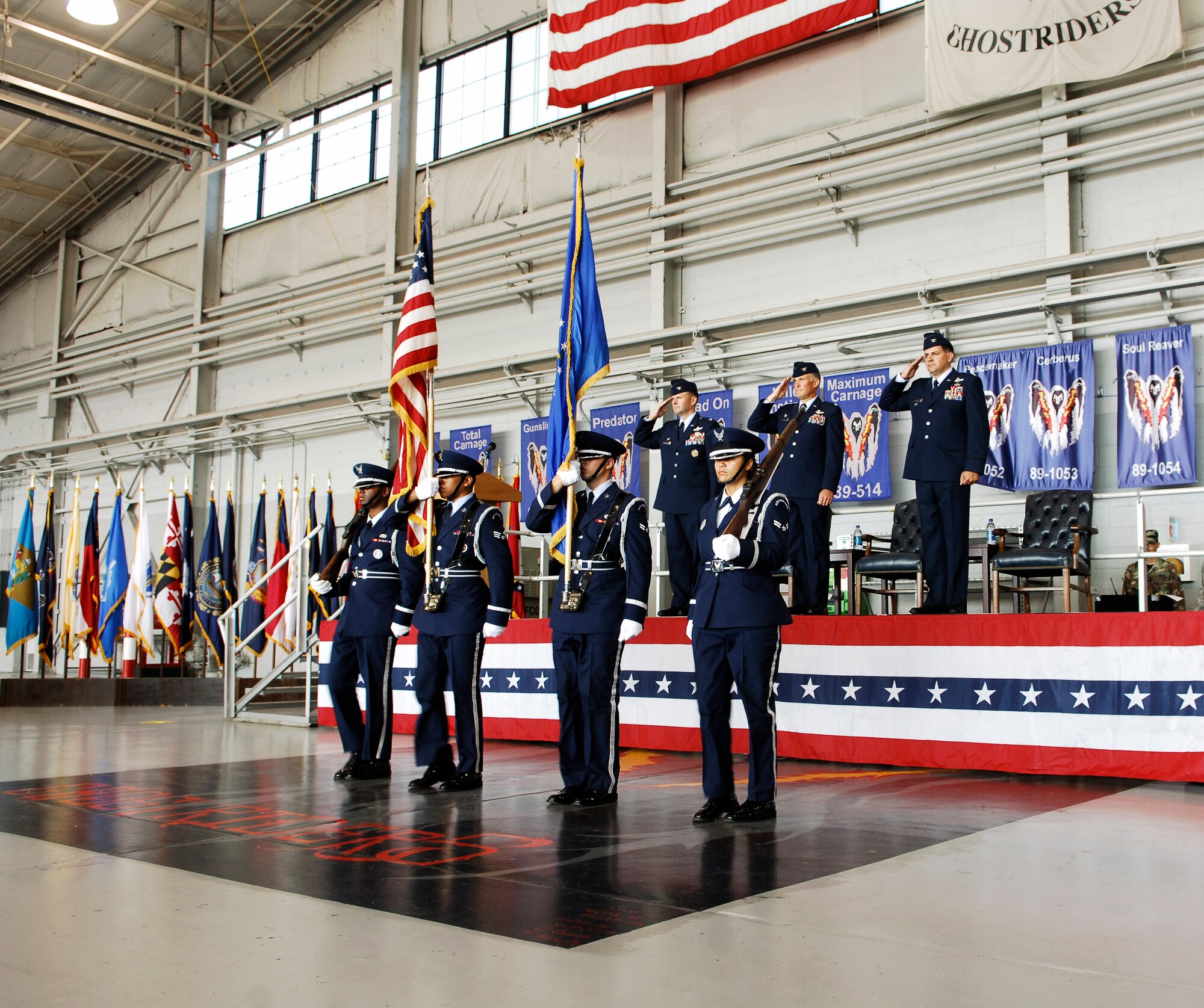 (from left to right) Col. Gregory Lengyel,1st Special Operations Wing commander, Col. Dennis Pannell, 1st Special Operations Group commander and Col. Albert "Buck" Elton, incoming 1 SOG commander salute the colors as they pass to begin the change of command ceremony at the 4th Aircraft Maintenance Unit hangar July 2. Colonel Elton assumed command of a group consisting of eight squadrons, more than 70 aircraft and more than 1,400 personnel (U.S. Air Force photo/Senior Airman Sheila DeVera).