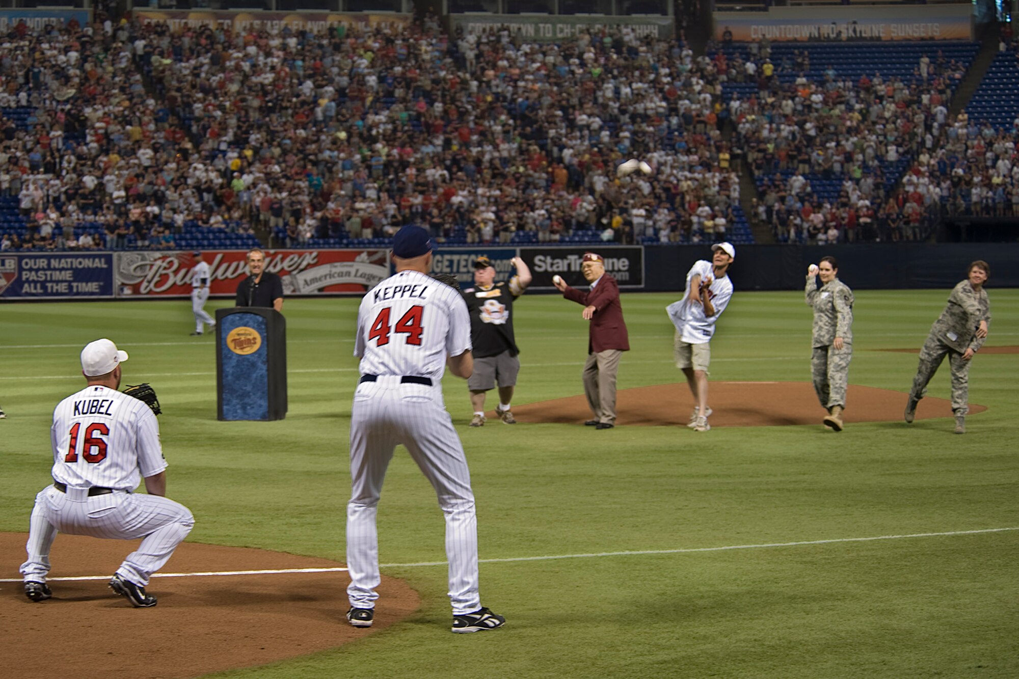 Master Sgt. Jamy Tikalsky (far right), a logistics planner with the 133rd Logistics Readiness Squadron, throws out the ceremonial first pitch at a Minnesota Twins game along with other military veterans on the mound during the Twins? seventh annual Armed Services Appreciation Day on July 5, 2009. Master Sgt. Tikalsky recently completed a tour in Afghanistan supporting Operation Enduring Freedom along with hundreds of other Airmen from the Minnesota Air National Guard?s 133rd Airlift Wing from St. Paul, Minn. The Minnesota Twins used the Fourth of July weekend game to honor all members of the armed services and their families during a game with the Detroit Tigers. The Twins defeated Detroit 2-6 in front of more than 33,000 fans. United States Air Force photo by Tech. Sgt. Erik Gudmundson (Released)