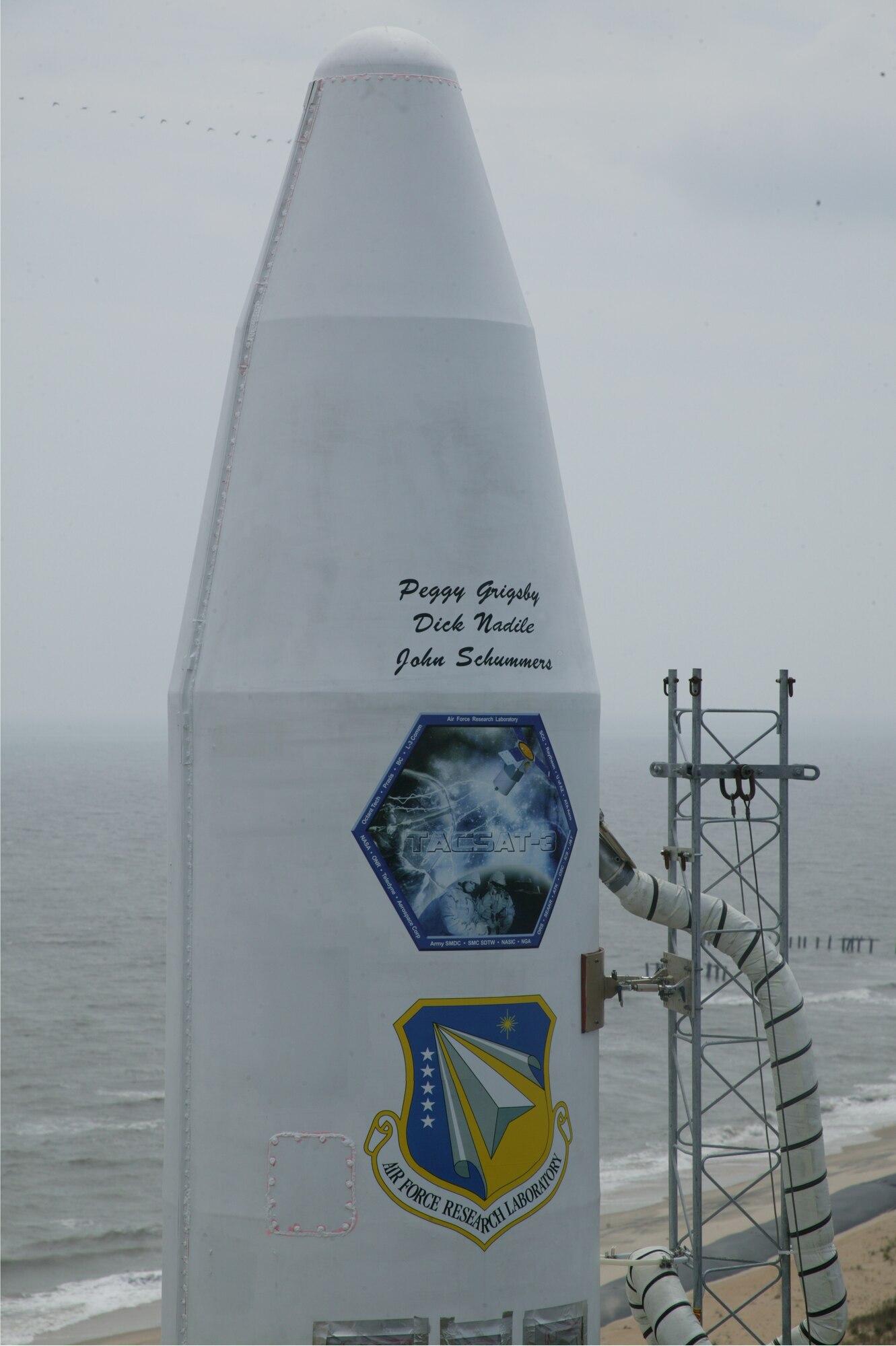 NASIC Analysts Ms. Peggy Grigsby’s name adorns the nosecone of a Minotaur rocket prior to launch.  The rocket launched an R&D satellite into space in 19 May 2009 and Ms. Grigsby received this honor in recognition for her years of spectral work that improved intelligence capabilities.   (Photo courtesy of U.S. Air Force)