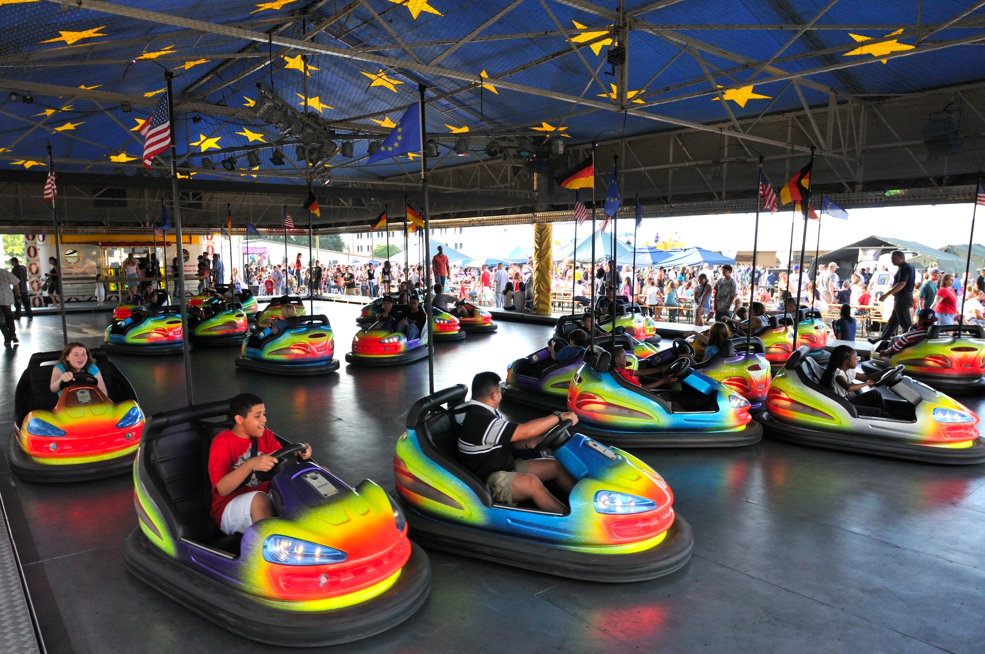 Military and civilian members ride bumper cars at the Rockin' Fourth of July celebration, July 4, 2009, Kapaun Air Station, Germany. Kaiserslautern Military Community members celebrated the event with games, rides and concerts and ended the night with fireworks. (U.S. Air Force photo by Staff Sgt. Stephen J. Otero)