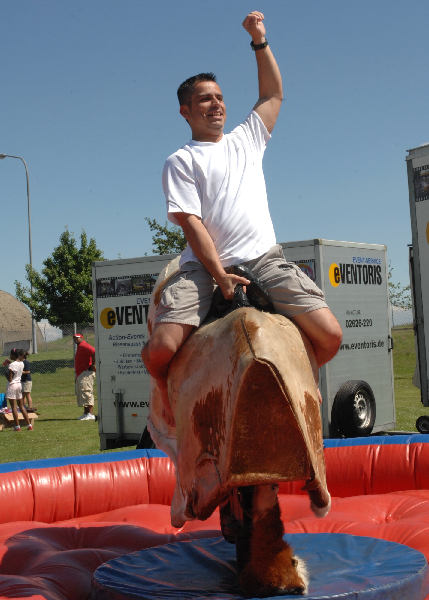 SPANGDAHLEM AIR BASE, Germany -- Master Sgt. Michael Garcia, 52nd Force Support Squadron first sergeant, rides a mechanical bull July 4 at Spangdahlem Air Base’s Super Saber Day.  Approximately 1,800 Sabers joined together to celebrate Independence Day near the base pavilions where 3,100 free meals were served, local bands entertained participants and a variety of activities were available for all ages, to include a mechanical bull, board games, face painting and paintball. (U.S. Air Force photo by Senior Airman Jenifer H. Calhoun)