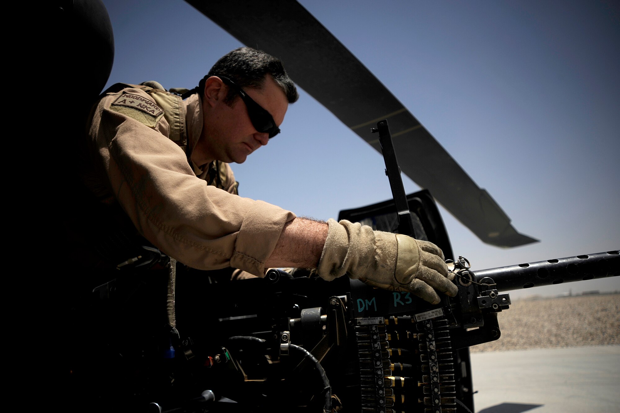 U.S. Air Force Tech. Sgt. Brock Woodward, flight engineer with the 129th Expeditionary Rescue Squadron, performes a preflight inspection of a .50 caliber machine gun June 23, 2009, Camp Bastion Afghanistan. (U.S. Air Force Staff Sgt. Shawn Weismiller)
