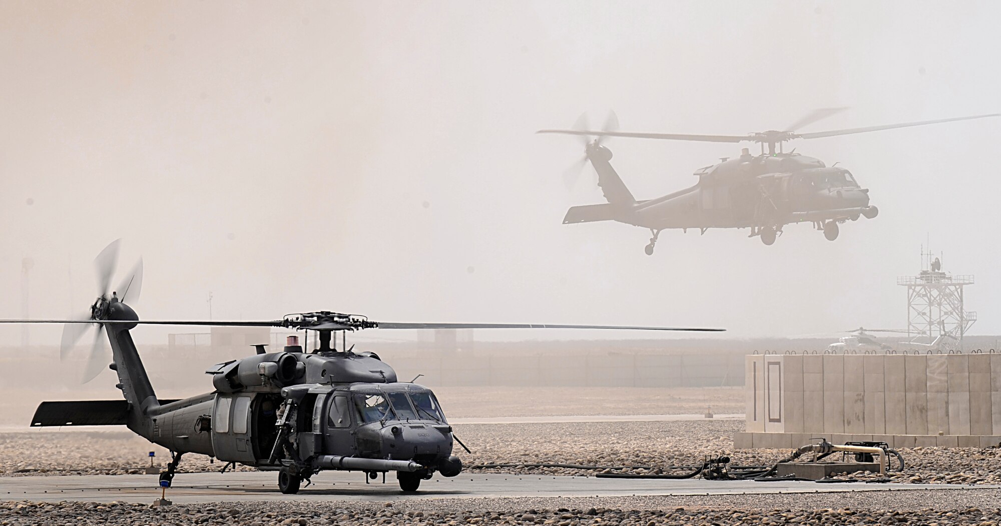 U.S. Air Force HH-60G Pave Hawks refuel after conducting combat operations in Hemland Province, Afghanistan, June 23. (U.S. Air Force photo by Staff Sgt. Shawn Weismiller)