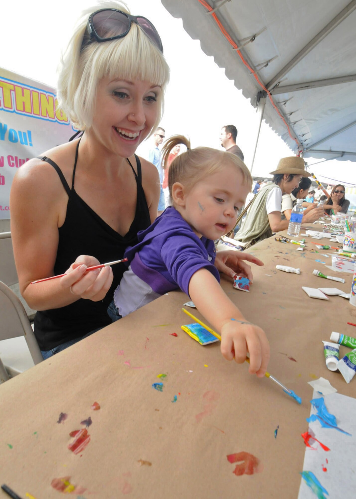 YOKOTA AIR BASE, Japan--Laura Lewis and daughter Kairi paint American themed ceramic magnets July 4. This Independence Day the 374th Force Support Squadron provided Yokota residents and their guests with events for all ages. The day kicked off with the Firecracker 5K fun run and a wide variety of activities throughout the day such as go-carts, petting zoo, live entertainment, food and a fireworks grand finale. (U.S. Air Force photo/ Staff Sgt. Veronica Pierce)