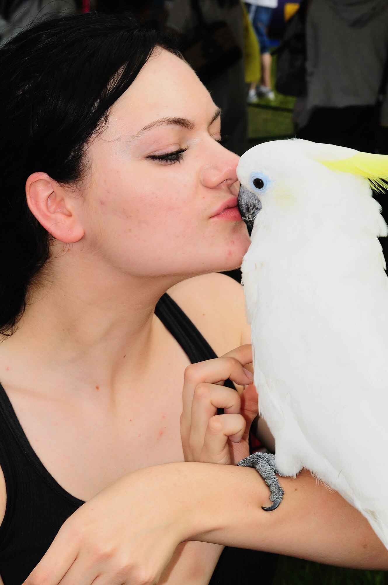 YOKOTA AIR BASE, Japan -- Airman First Class Kendra Silcox,  374th Logistics Readiness Squadron receiving apprentice, holds a Cockatoo July 4, at the petting zoo during the Celebrate America fourth of July festival. Celebrate America is a day-long Independence Day event that includes a scavenger hunt, 5K fun run, go-carts and musical performances. (U.S. Air Force photo/Airman First Class Devin Doskey) 