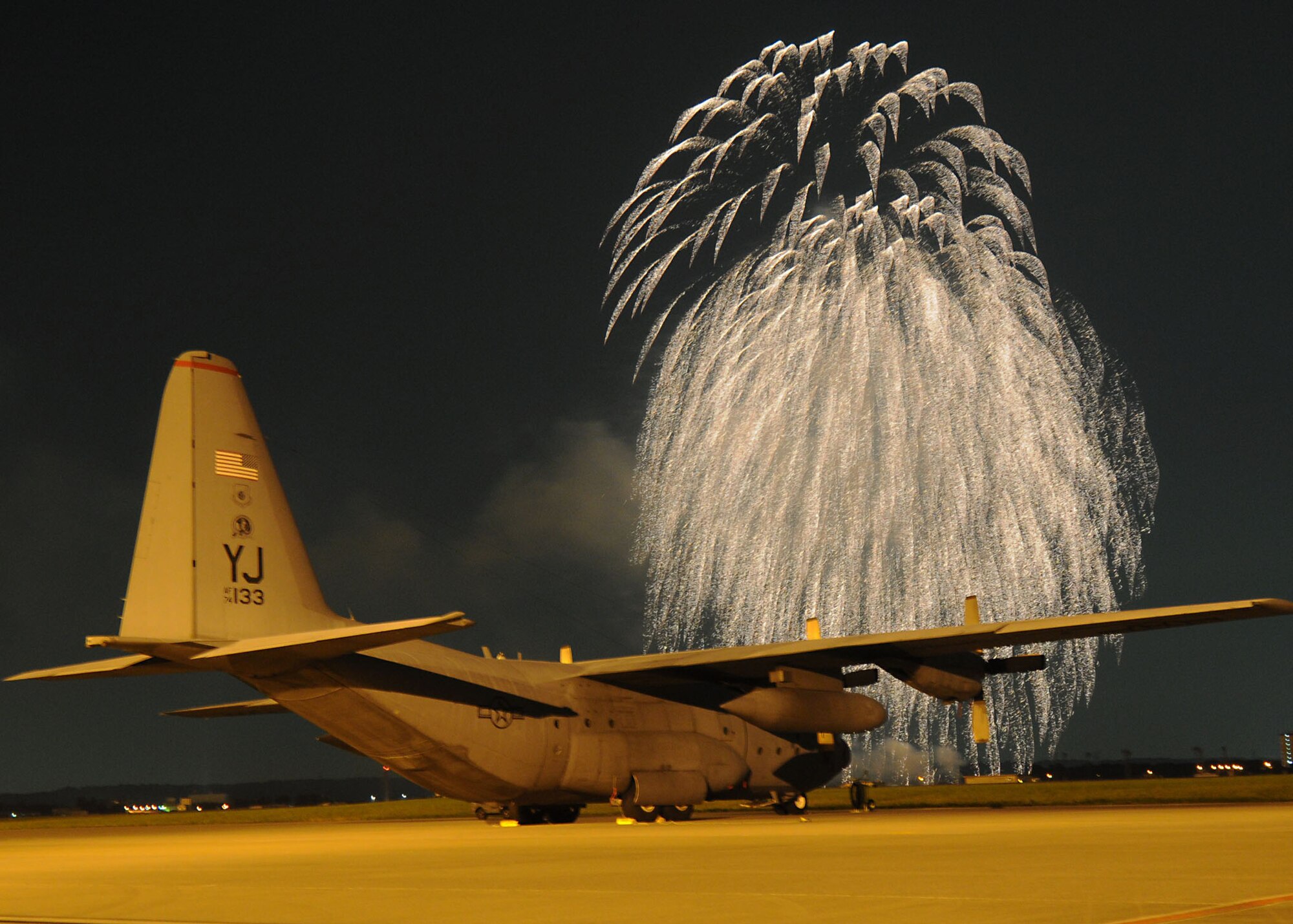 YOKOTA AIR BASE, Japan -- Fireworks erupt in front of a C-130 Hercules from the 36th Airlift Squadron July 4. This Independence Day the 374th Force Support Squadron provided Yokota residents and their guest with events for all ages. The day kicked off with the Firecracker 5K run and a wide variety of activities throughout the day such as go-carts, petting zoo, live entertainment, food and a firework grand finale. (U.S. Air Force photo/ Staff Sgt. Veronica Pierce)