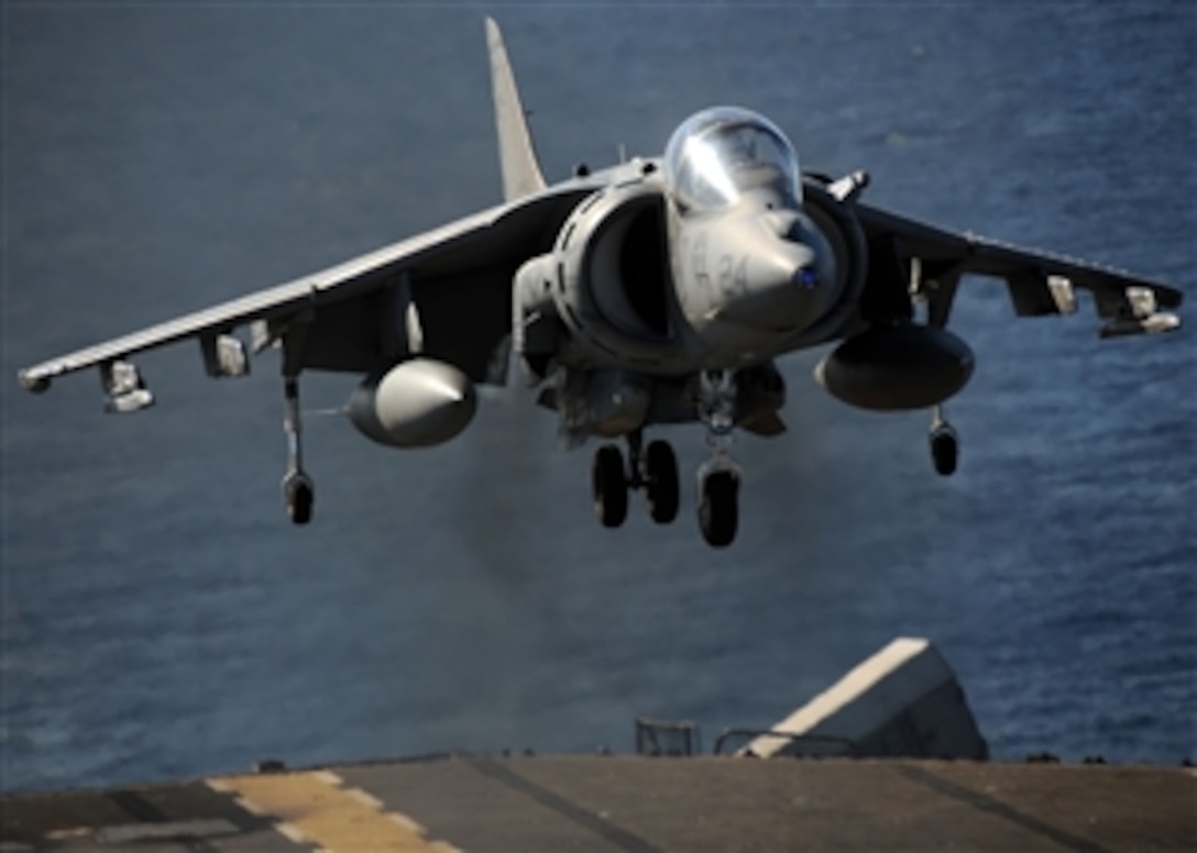 An AV-8B Harrier jet aircraft assigned to Marine Attack Squadron 211, embarked aboard the forward-deployed amphibious assault ship USS Essex (LHD 2), lands on the ship's flight deck while underway in the Coral Sea during a deck landing qualification evolution on July 7, 2009.  