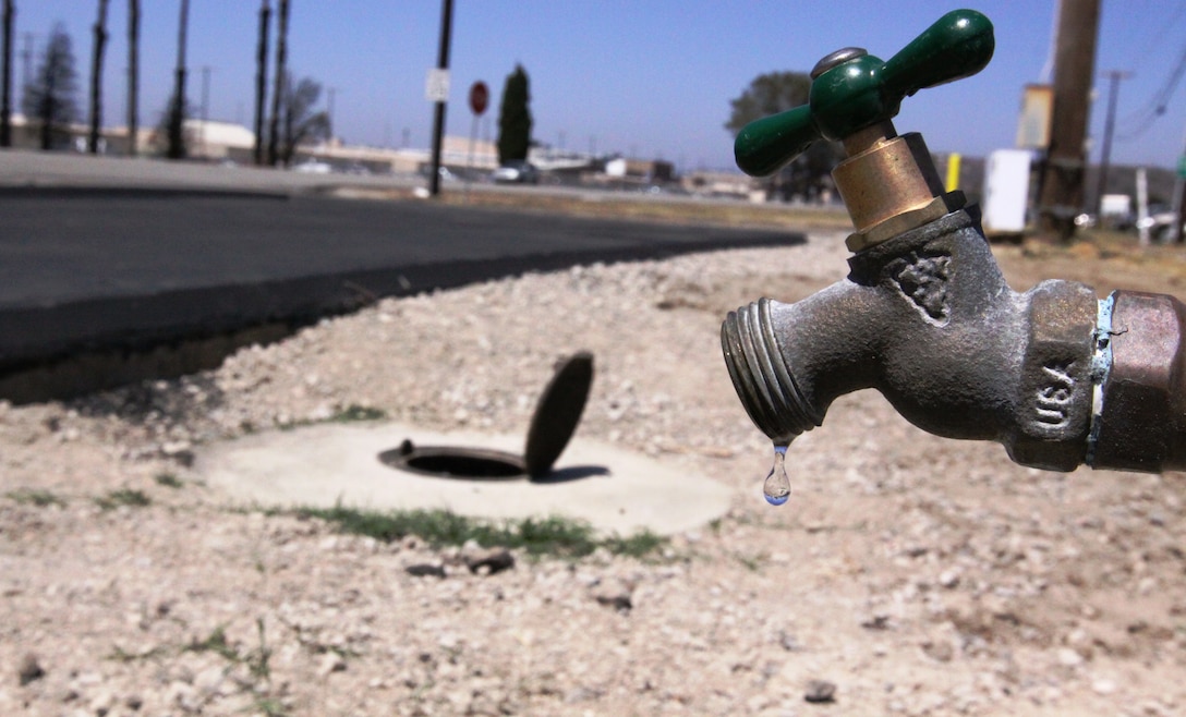 The potable water faucet seen above marks the completion of the six Fundraiser Vehicle Wash Stations on base with the sanitary sewer drain valve cover in the background, Jul. 7.