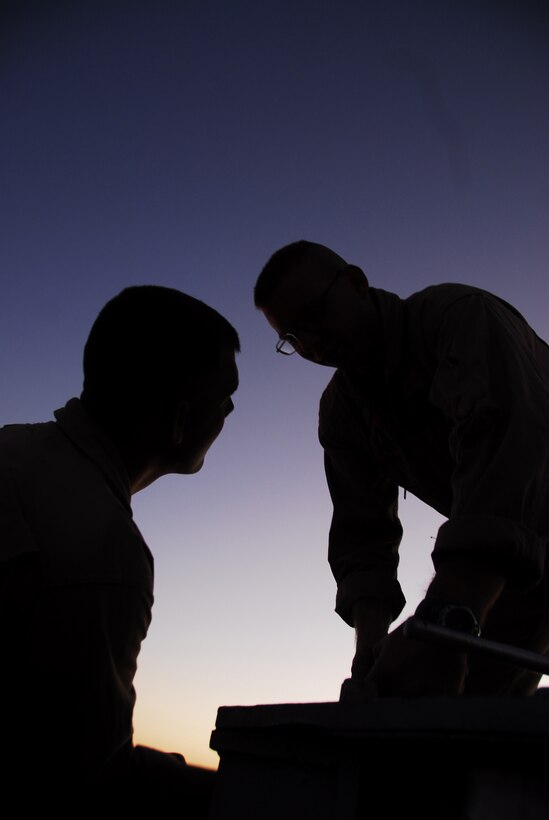 Emergency aircraft recovery crewmen Lance Cpl. Josh Kidwell and Lance Cpl. Tony Eck tighten bolts on one of four sets of arresting gear on the flight line at the Marine Corps Air Station in Yuma, Ariz., July 7, 2009. The recovery crew repaired gear that was out of operation for more than two years. The device uses a heavy steel cable and heavy nylon tapes to rapidly decelerate landing aircraft in an emergency, much like the arresting gear on an aircraft carrier.