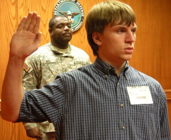 Staff Sgt. Matthew Vetch enlisted his son on July 1, 2009 at the Military Entrance Processing Station in Omaha, Nebraska. Vetch and his 17-year-old son Luke, pose at Vetch’s Permanent Contact Station Norfolk, Recruiting Substation Sioux City, Recruiting Station Des Moines office. Vetch, who by trade is a wire chief, and his son, who signed up to be an infantryman, hope the odds are on their side to get stationed together.