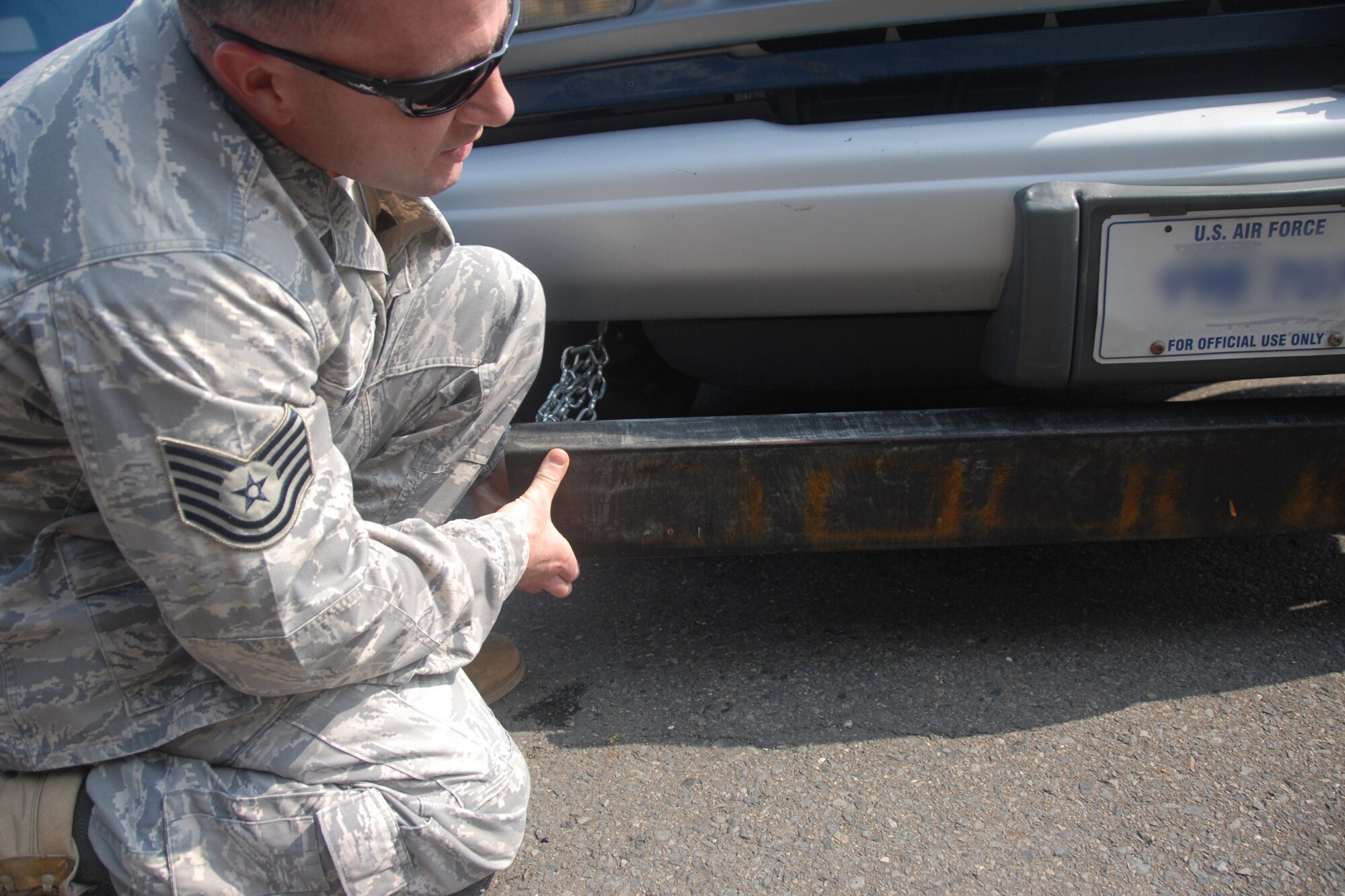 Tech. Sgt. Ernest Valley, 35th Fighter Wing Foreign Object Damage monitor, looks underneath a specialized flightline vehicle with a large magnet attached to the front of the vehicle frame to view what metal pieces it picked up. This FOD prevention equipment finds smaller pieces that may have been overlooked. (U.S. Air Force photo/Senior Airman Stefanie Torres)