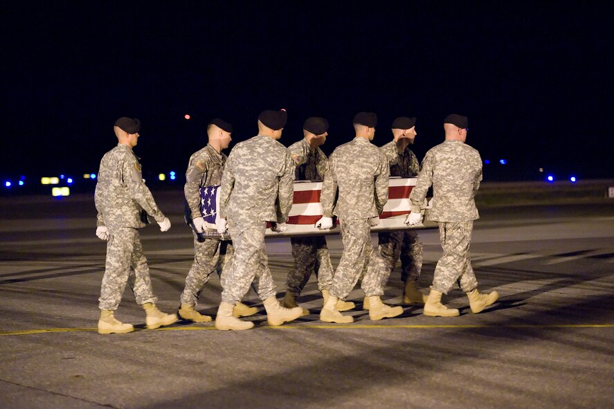 An Army carry team transfers the remains of Army Pfc. Aaron E. Fairbairn, 20, of Aberdeen, Wash., at Dover Air Force Base, Del., July 6. Private Fairbairn was assigned to the 3rd Battalion, 509th Parachute Infantry Regiment, 4th Brigade Combat Team (Airborne), 25th Infantry Division, Fort Richardson, Alaska. (U.S. Air Force photo/Tom Randle)