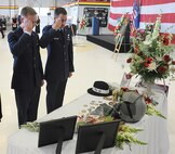 Capt. Benjamin Meier, left, and 1st Lt. Mike Pacini, both of the 421st Fighter Squadron, salute in remembrance of Capt. George Houghton, 421st FS, at a memorial service held at Hill AFB in his memory June 26.  (U.S. Air Force photo by Alex R. Lloyd)
