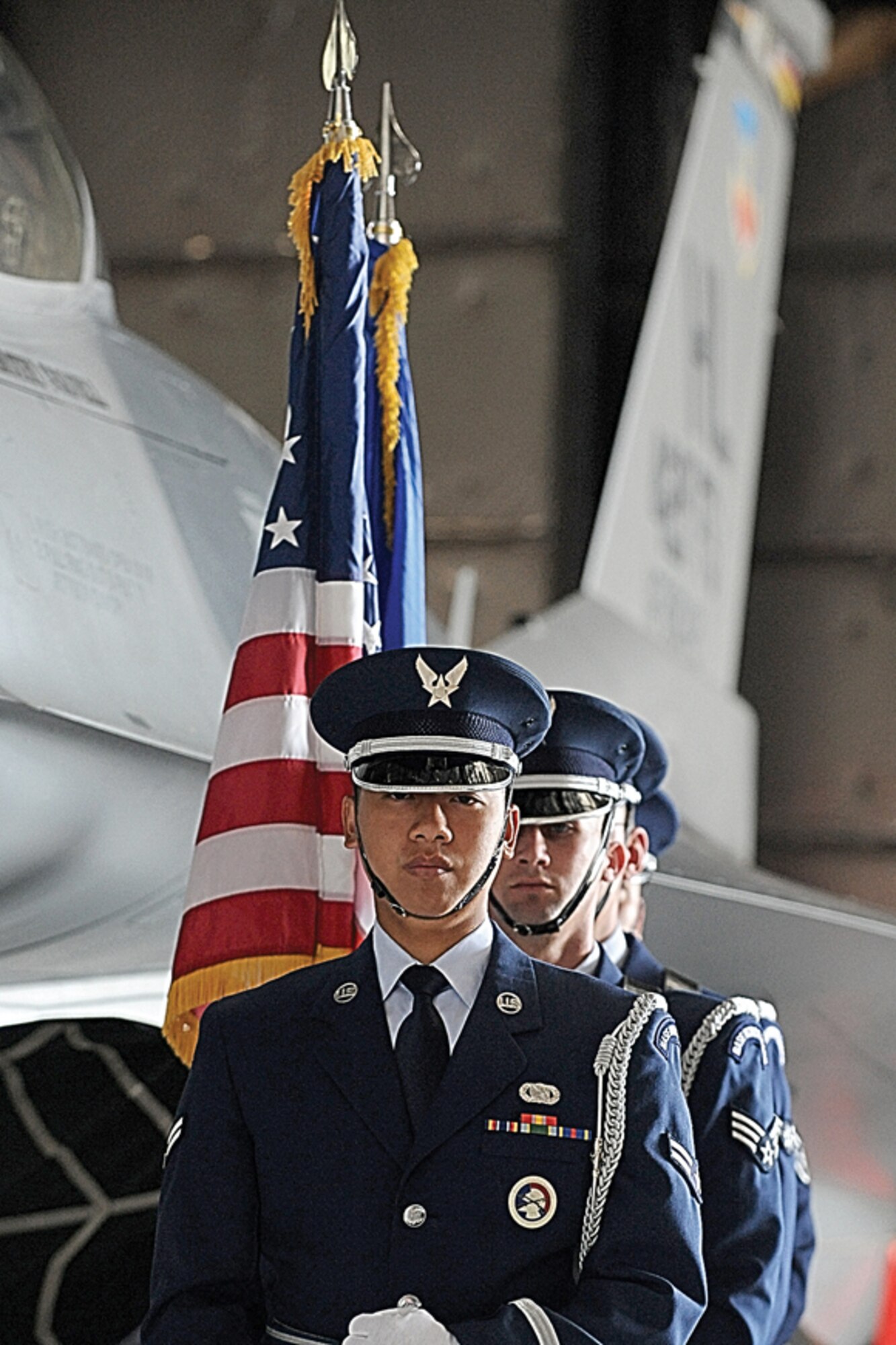 The Hill Air Force Base Honor Guard stand beside the 421st Fighter Squadron F-16 Fighting Falcon in Hangar 37 before a memorial service June 26 for Capt. George Houghton.  Captain Houghton, 421st FS pilot, died during an F-16 accident at the Utah Test and Training Range June 22.