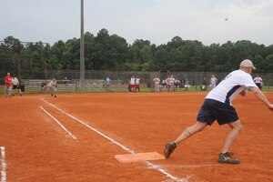 Matthew Pease prepares to run to second base as his teammate hits the ball into left field during an intramural softball game here at the softball fields July 7. Security Forces beat the Aircraft Maintenance Squadron team one 13-1. Pease is with the 437th SFS. (U.S. Air Force photo/Senior Airman Katie Gieratz)