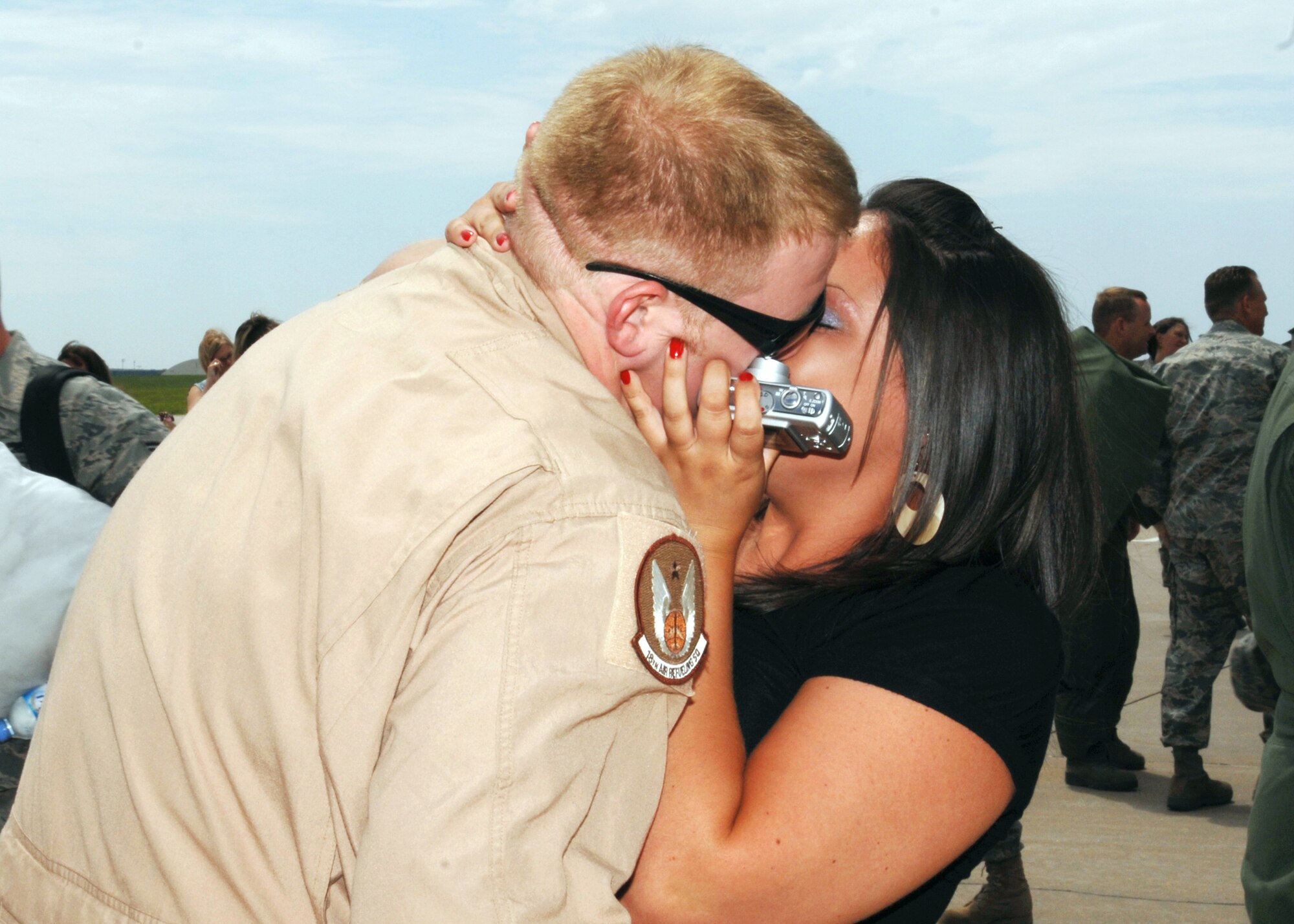 Tech. Sgt. Christopher "Hollywood" Norris receives a welcome-home kiss after returning to McConnell Air Force Base, Kan., on July 2 from a deployment to Southwest Asia. Sergeant Norris is a Reservist assigned to the 931st Air Refueling Group, an Air Force Reserve unit at McConnell AFB. (U.S. Air Force photo/Staff Sgt. Jamie Train)