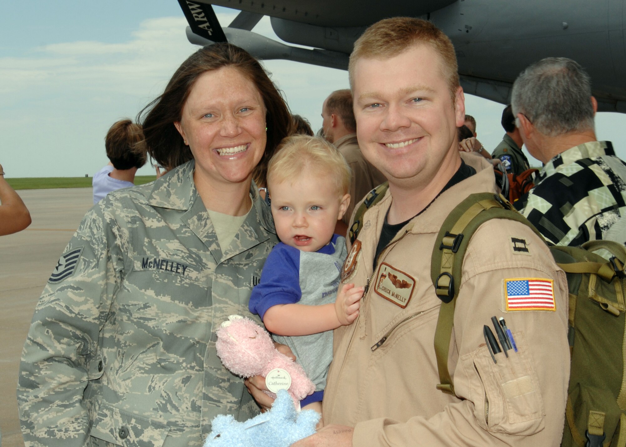 A happy McNelley family is reunited at McConnell Air Force Base, Kan., on July 2. Capt. Charley McNelley, a Reservist assigned to the 931st Air Refueling Group at McConnell, returned from a deployment to Southwest Asia. His wife, Tech. Sgt Rebecca McNelley, is an active-duty Airmen assigned to the 22nd Air Refueling Wing, the 931st's host unit at the base. Their son, Jacob, is 2 years old. (U.S. Air Force photo/Staff Sgt. Jamie Train)
