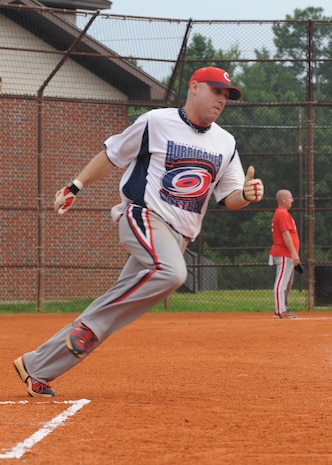 Gary Reash rounds first base during a game between the Aircraft Maintenance Squadron team one and Security Forces Squadron at the base softball fields July 7. SFS beat AMXS team one 13-1. Reash is with the 437th SFS.(U.S. Air Force photo/Senior Airman Katie Gieratz)