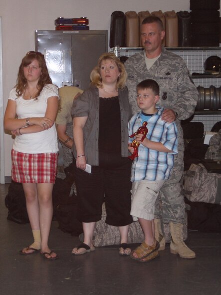 WRIGHT-PATTERSON AIR FORCE BASE, Ohio – Master Sgt. Greg Myers, 445th Security Forces Squadron, receives last minute instructions for his deployment while his wife, Lenore, and children, Alexandra and Nathan listen.  Sergeant Myers and 12 other reservists from the SFS deployed to Kirkuk Regional Air Base, Iraq, July 6.  The group will be gone for six months. (Air Force photo/Stacy Vaughn)