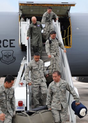 Airmen from the 506th Expeditionary Air Refueling Squadron remove belongings from a KC-135 Stratotanker after it lands at Andersen Air Force Base, Guam.  The KC-135 returned from a deployment to Alaska after an exercise, Northern Edge 2009, to practice mission planning and procedures.  The KC-135s are deployed here to support of the U.S. Pacific Command's Theater Security Package in the Asia-Pacific Region. (U.S. Air Force photo/ Senior Airman Christopher Bush)
