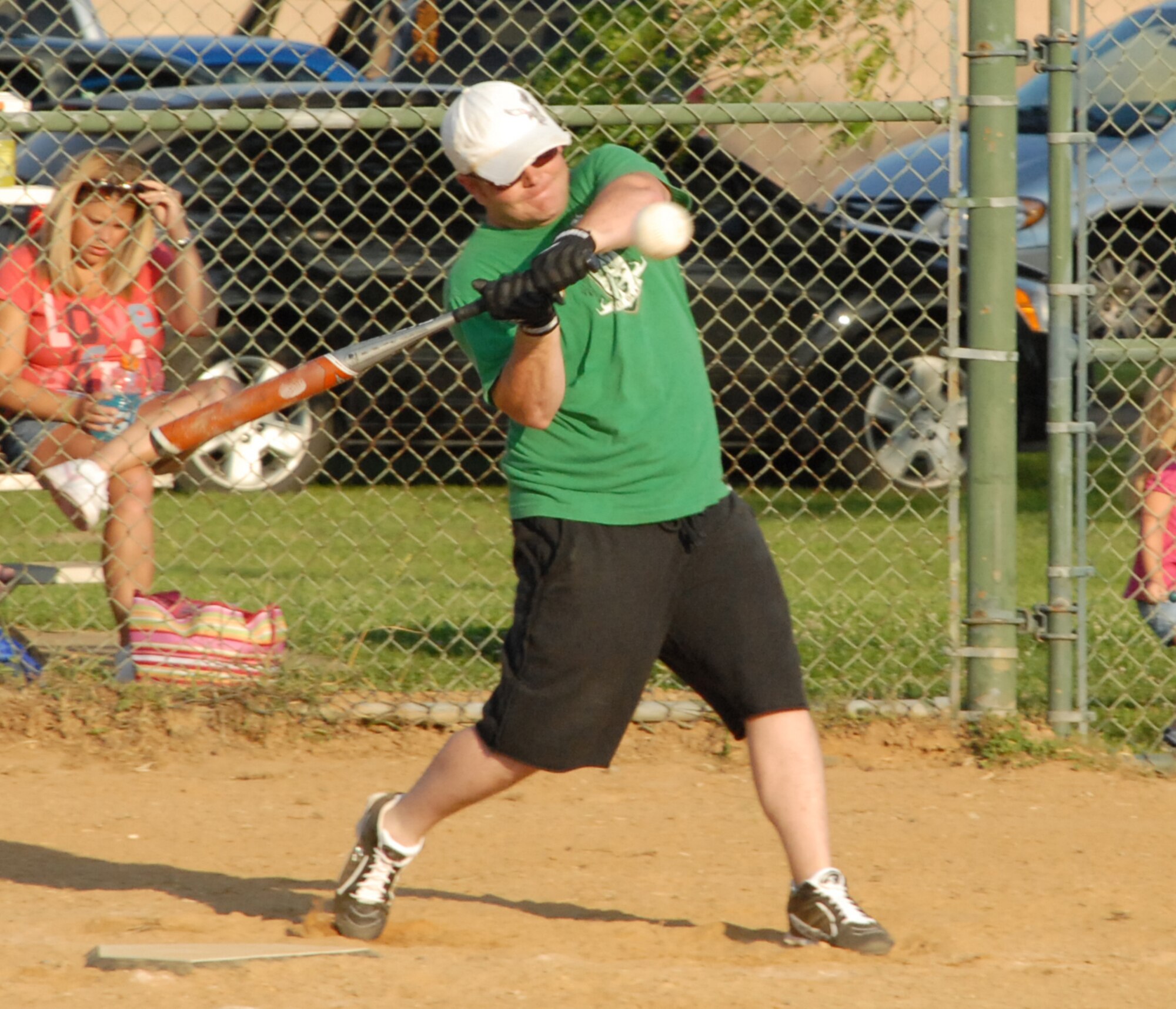 John Haggerty, 436th Aircraft Maintenance Squadron catcher, hits a ball to deep left field June 29.  436th AMXS defeated the 436th Civil Engineer Squadron 16-6.  (US Air Force photo/Staff Sgt. Chad Padgett)
