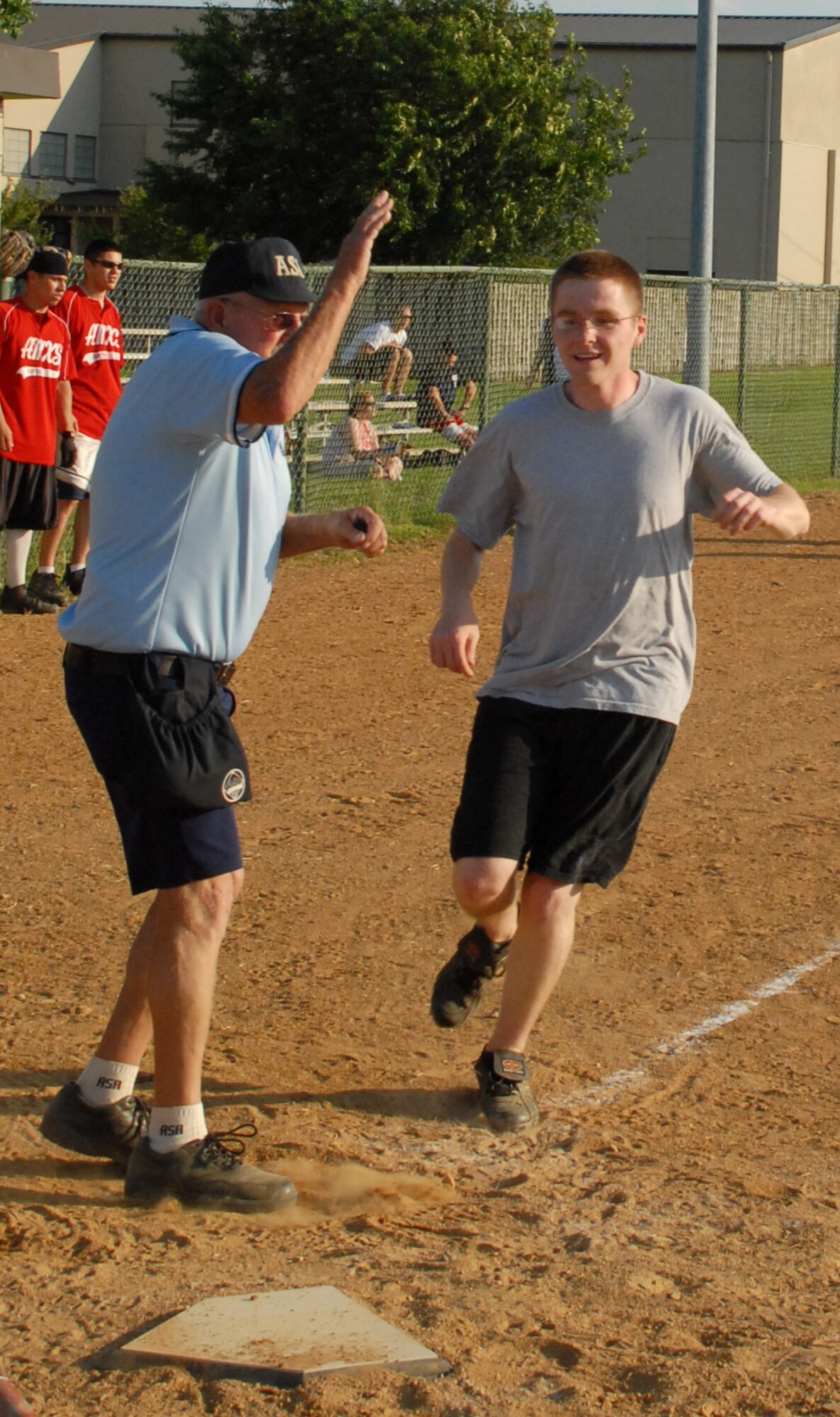 Brandon Lumsden, 436th Aircraft Maintenance Squadron shortstop, scores a run against the 436th Civil Engineer Squadron June 29.   436th AMXS defeated 436th CES 16-6.  (US Air Force photo/Staff Sgt. Chad Padgett)