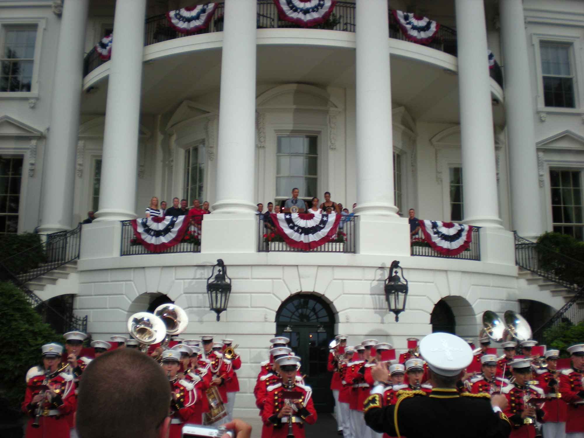 The Marine Corps Band plays the Air Force song as President Barack Obama watches from a balcony overlooking the White House South Lawn during an Independence Day ceremony July 4. More than 70 Dover Air Force Base Airmen and their families got the opportunity to celebrate the 4th of July with the President at his home. (U.S. Air Force photo/Staff Sgt. Stephen Hart)