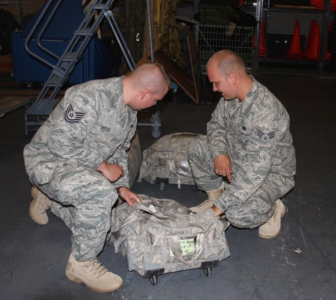 WRIGHT-PATTERSON AIR FORCE BASE, Ohio – Tech. Sgt. Tom Sexton, left, gives his brother, Senior Airman Tim Sexton, both from the 445th Security Forces Squadron, last minute advice before deploying to Kirkuk Regional Air Base, Iraq, July 6 with 11 other reservists from the SFS. The reservists will be gone for six months. (Air Force photo/Stacy Vaughn)