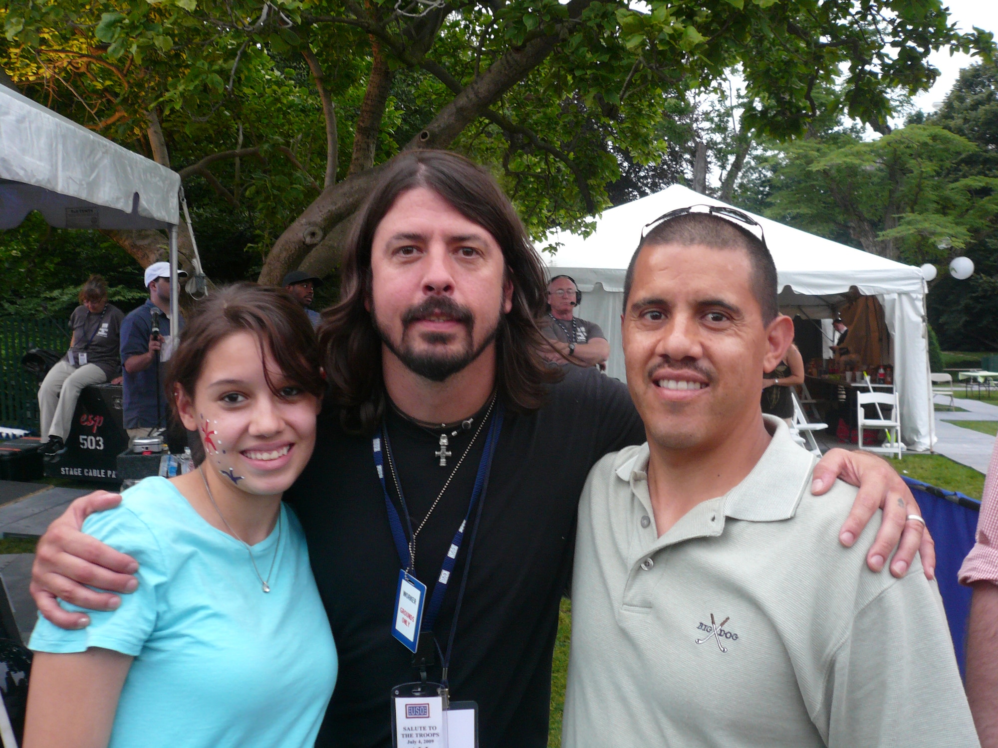(Right) Tech. Sgt. Antonio Infante, 436th Airlift Wing Legal Office Military Justice NCO-in charge; and his daughter, Brittany Infante (left), pose with the Foo Fighters lead singer Dave Grohl on the White House South Lawn during an Independence Day celebration there July 4. (Courtesy photo)