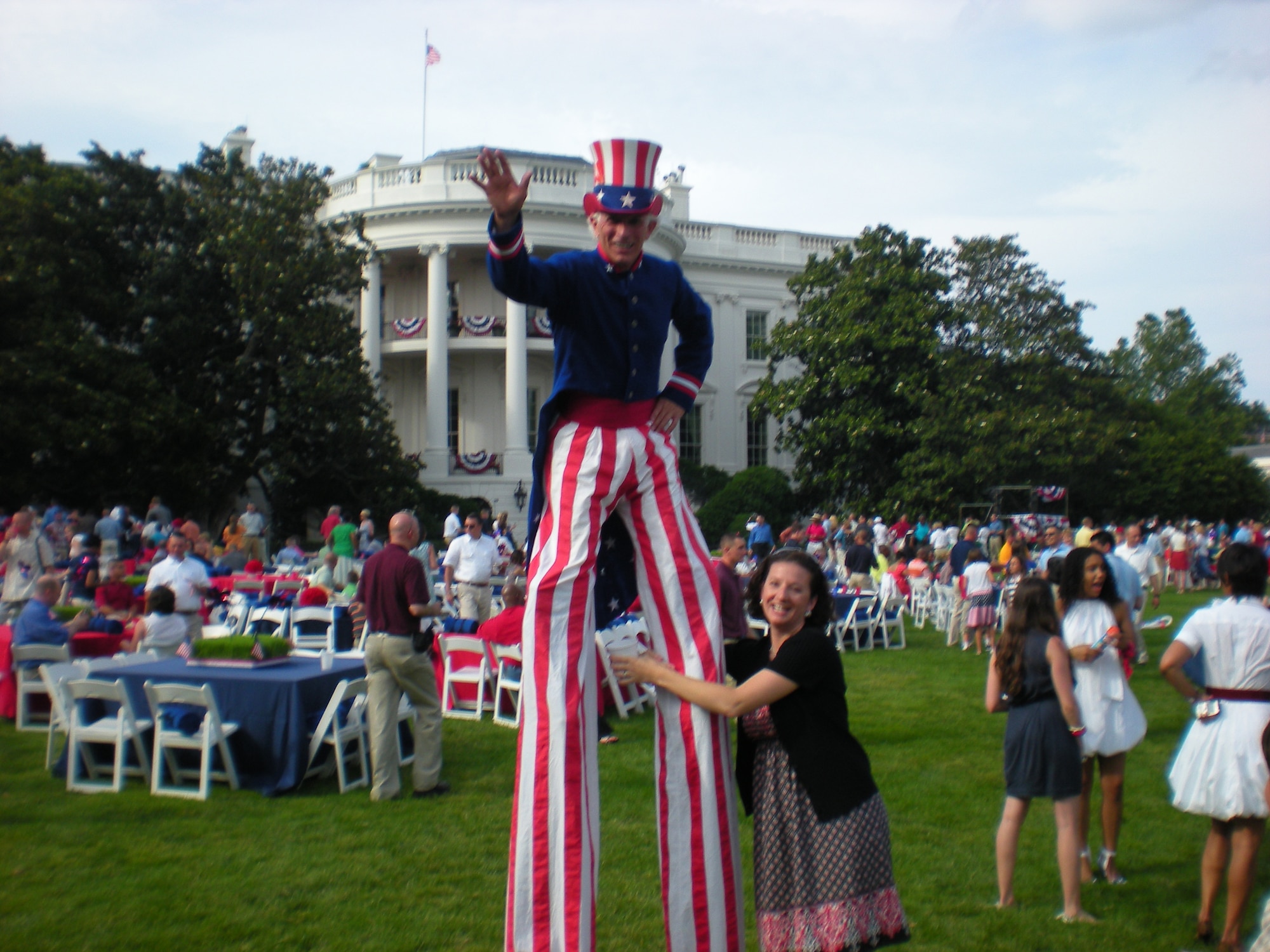 Stacy Hart, wife of Staff Sgt. Stephen Hart, 436th Maintenance Operations Squadron, stands beside ?Uncle Sam? on the White House South Lawn during a Independence Day celebration July 4. The South Lawn was packed with entertainment ranging from celebrities to balloon animals and volleyball games. (U.S. Air Force photo/Staff Sgt. Stephen Hart)