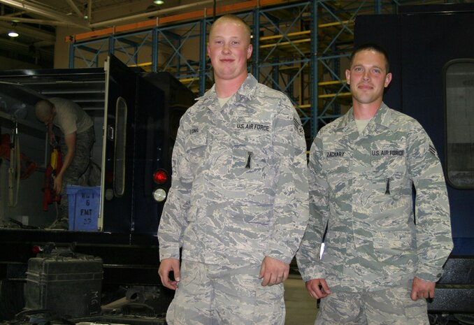 Senior Airmen Kyle Long and Christopher Zachary, 341st Maintenance Operations Squadron, pose inside Malmstrom's 3-bay hangar. (U.S. Air Force photo/Senior Airman Dillon White) 