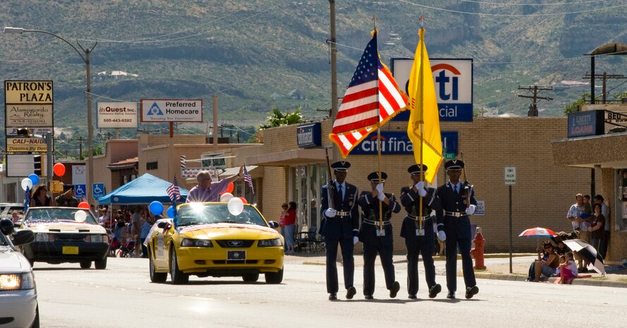 Members of the Steel Talons Honor Guard flag detail from Holloman Air Force Base, N.M., lead the 4th of July parade in Alamogordo, N.M. Members carried the U.S. flag and the New Mexico state flag, while leading Grand Marshall New Mexico Congressman Harry Teague and honored guests along the parade route. (U.S. Air Force Photographer TSgt Alan Port Released)