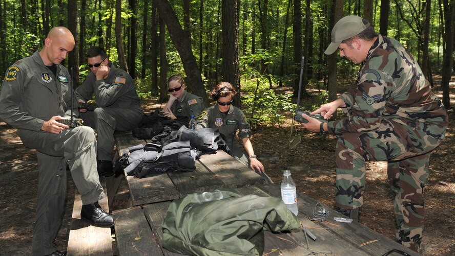 Senior Airmen Justin Pishner, 4th Operations Support Squadron, explains the proper use of a global positioning satellite to aircrew from the 916th Air Refueling Wing during combat survival training at the Cliffs of the Neuse State Park, N.C., July 2, 2009. All aircrew complete approximately 12 hours of survival training every 36 months. Airmen Pishner is a Survival, Evasion, Resistance and Escape instructor. (U.S. Air Force photo by Airman 1st Class Gino Reyes)