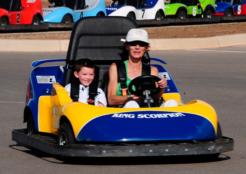 Deedee Lasalle drives a go kart with her grandson River Redmon during the Fourth of July celebration at Holloman Air Force Base, N.M. (U.S. Air Force Photo/Tech.Sgt. Chris Flahive)
