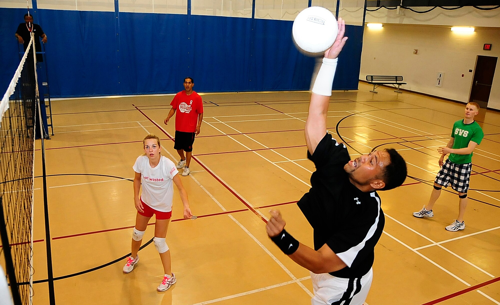 Mr. Josh Faiai spikes a perfectly set ball during the Sports and Fitness Centers volleyball tournament at Holloman Air Force Base, N.M, July 4. Mr Faiai works for the 49th Services Squadron with Ms. Jamie Crossman, Mr. Ben Soliaita and Senior Airman Corey Dufresne, his teammates. (U.S. Air Force Photo/Tech.Sgt. Chris Flahive)