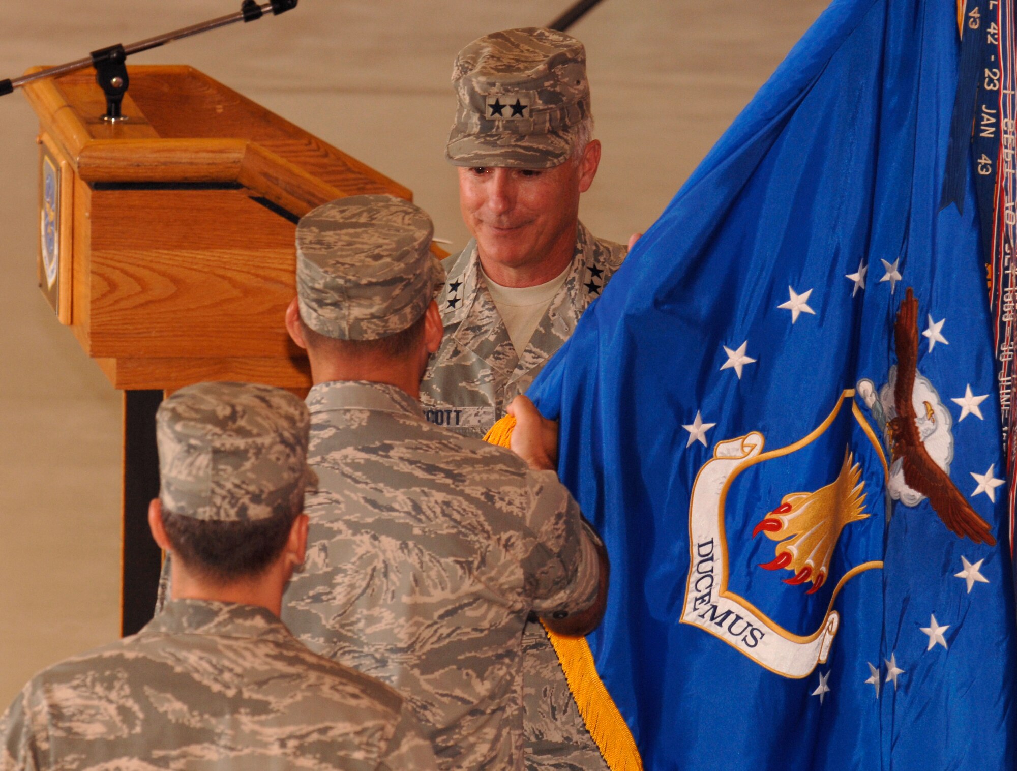 MCCONNELL AIR FORCE BASE, Kan. -- Maj. Gen. Winfield W. Scott III, 18th Air Force commander, receives the McConnell guidon from Col. James C. Vechery, former 22nd Air Refueling Wing commander, during a change of command ceremony in hangar 1176, July 2. Colonel Vechery stepped out of the wing commander position to move to Travis Air Force Base where he will become the new commander of the 60th Air Mobility Wing. (Photo by Senior Airman Laura Suttles)